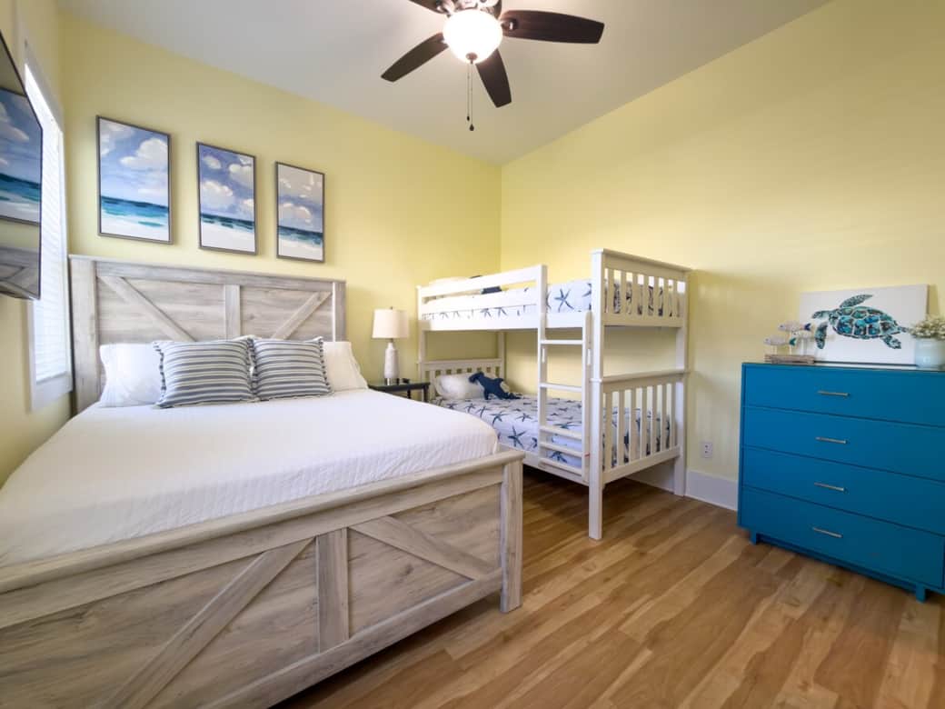 Family-friendly second-floor suite with a queen bed, bunk bed, private full bath, and Smart TV.