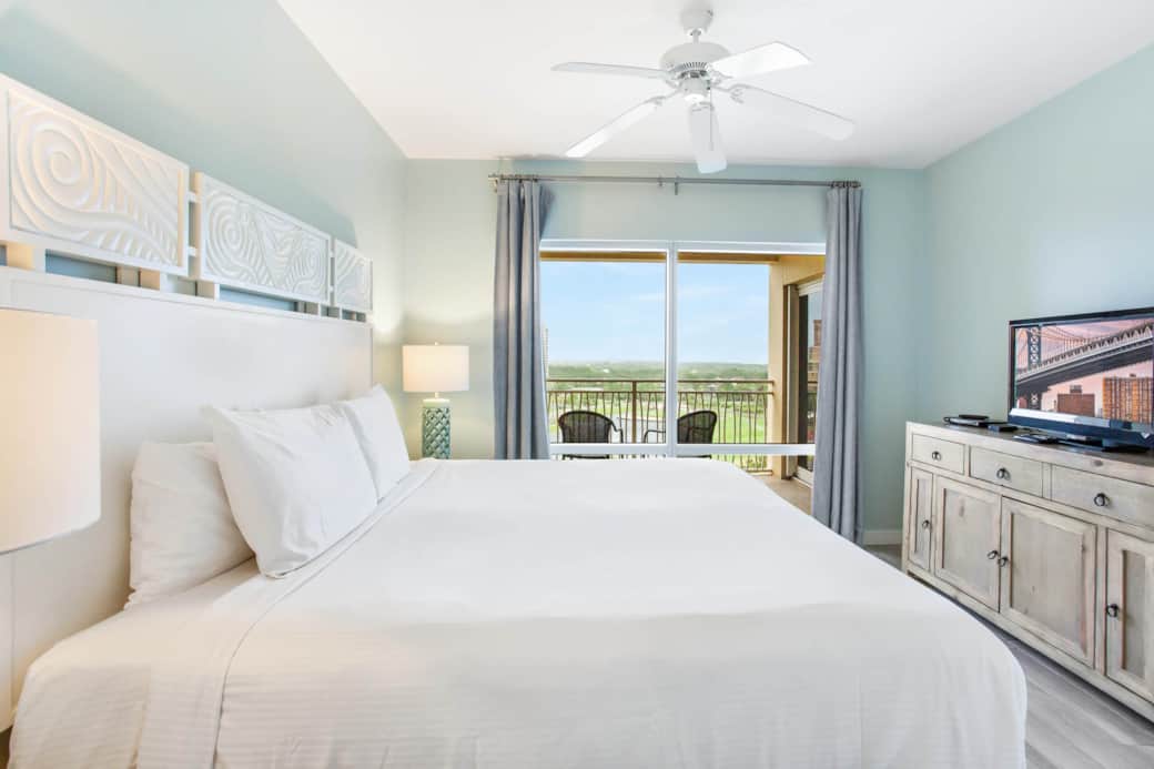 Bedroom with resort and beach views
