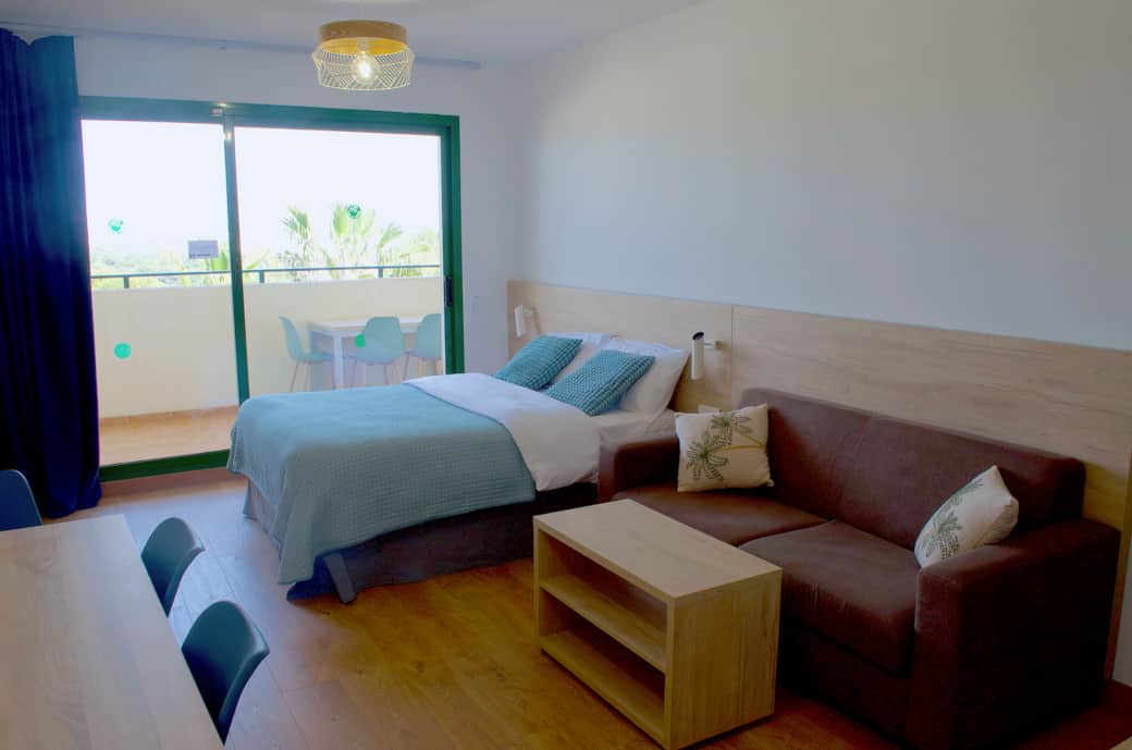 Living room with a double bed and sofa