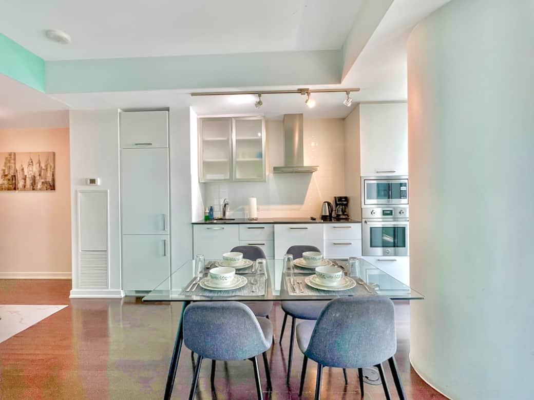 Enjoy meals together in a cozy dining area that comfortably seats four. Whether it’s a quick breakfast or a relaxed dinner, this space is perfect for sharing food, laughter, and great conversations with a stunning city backdrop.