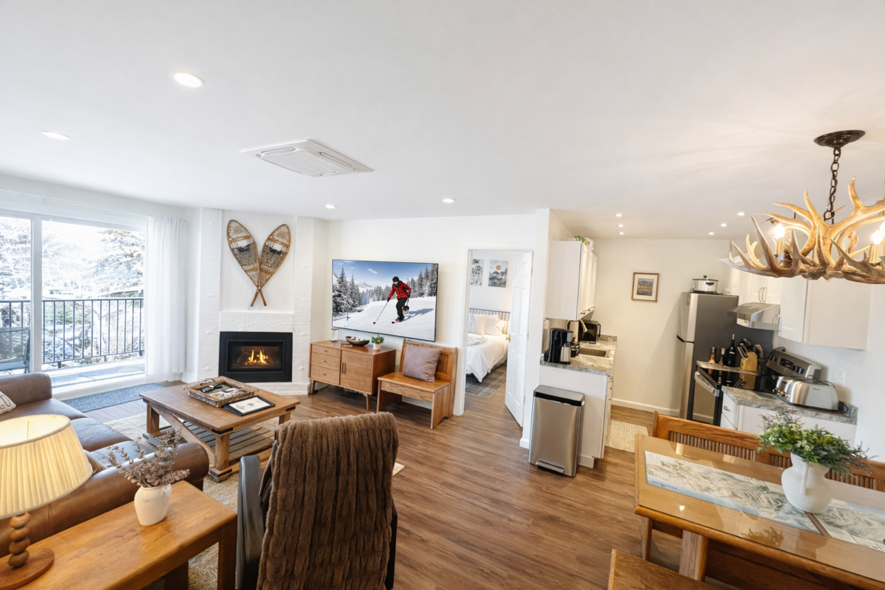 Open living room and kitchen with 72" Smart TV