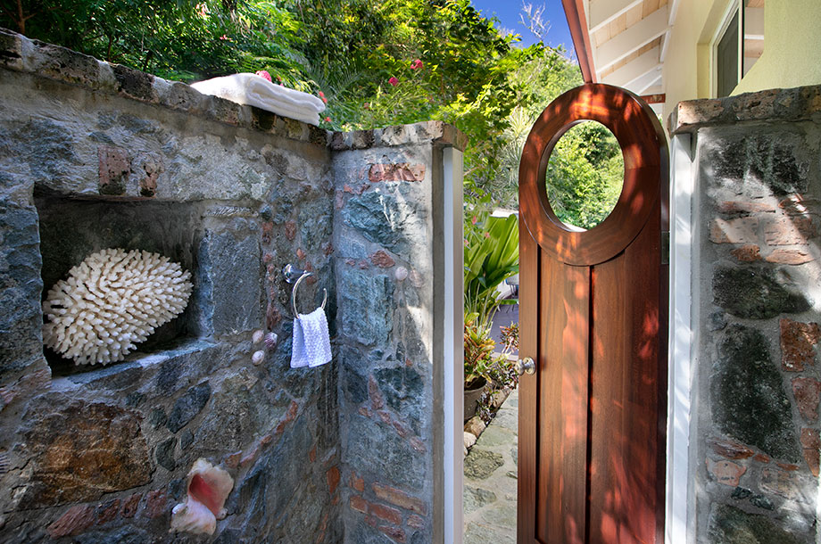 Second bedroom outdoor stone shower with door to the pool deck