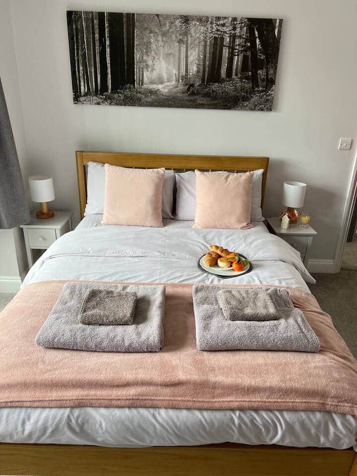 John Lewis Double bed with freshly cleaned and ironed sheets.