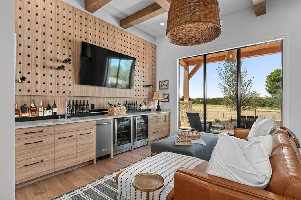 Unwind while using the amenities of the living room lounge area including an additional sink, ice machine, and refrigeration. 