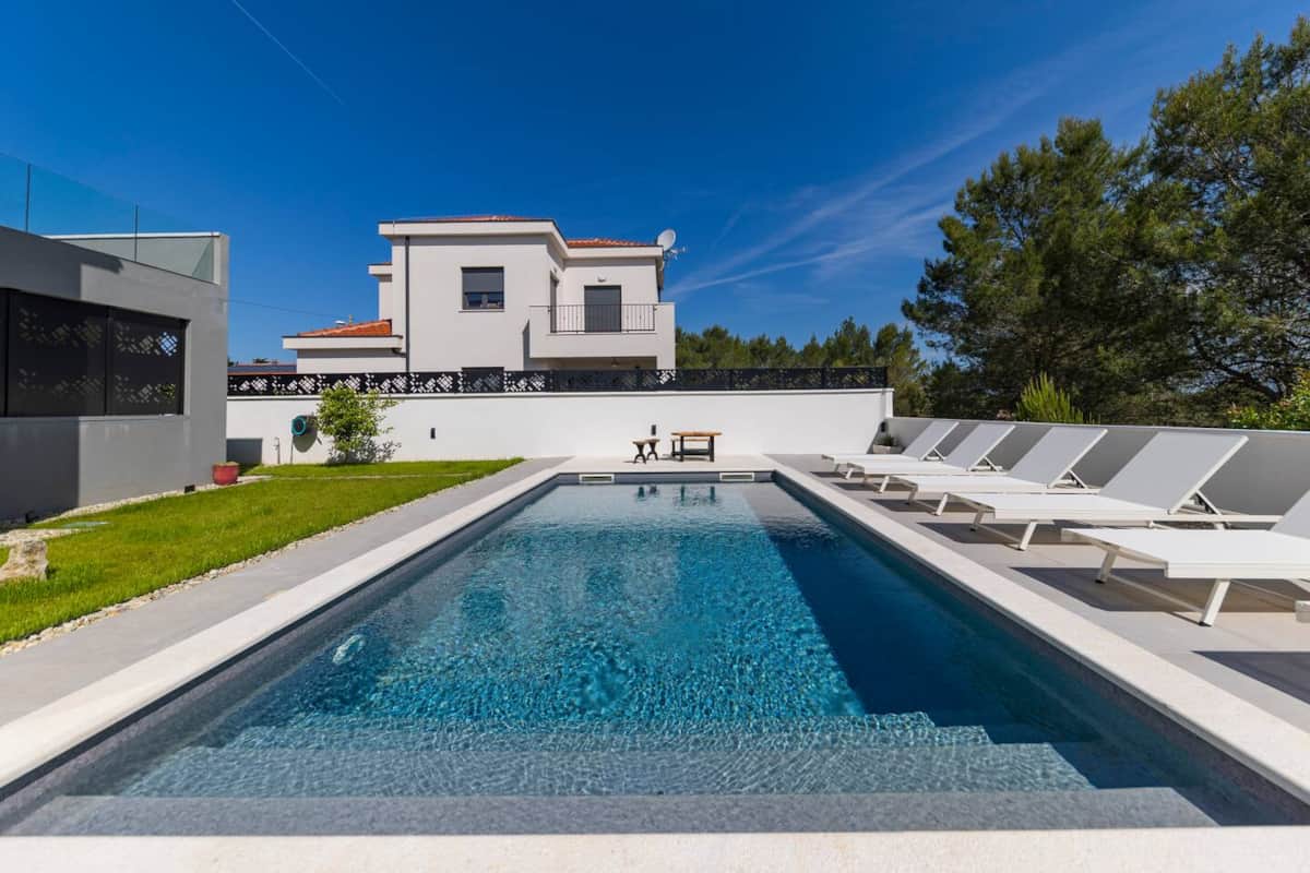 Private pool with sun loungers beside Alba Family Home
