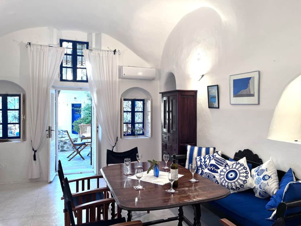 Bright Santorini living room with cozy seating and traditional décor..