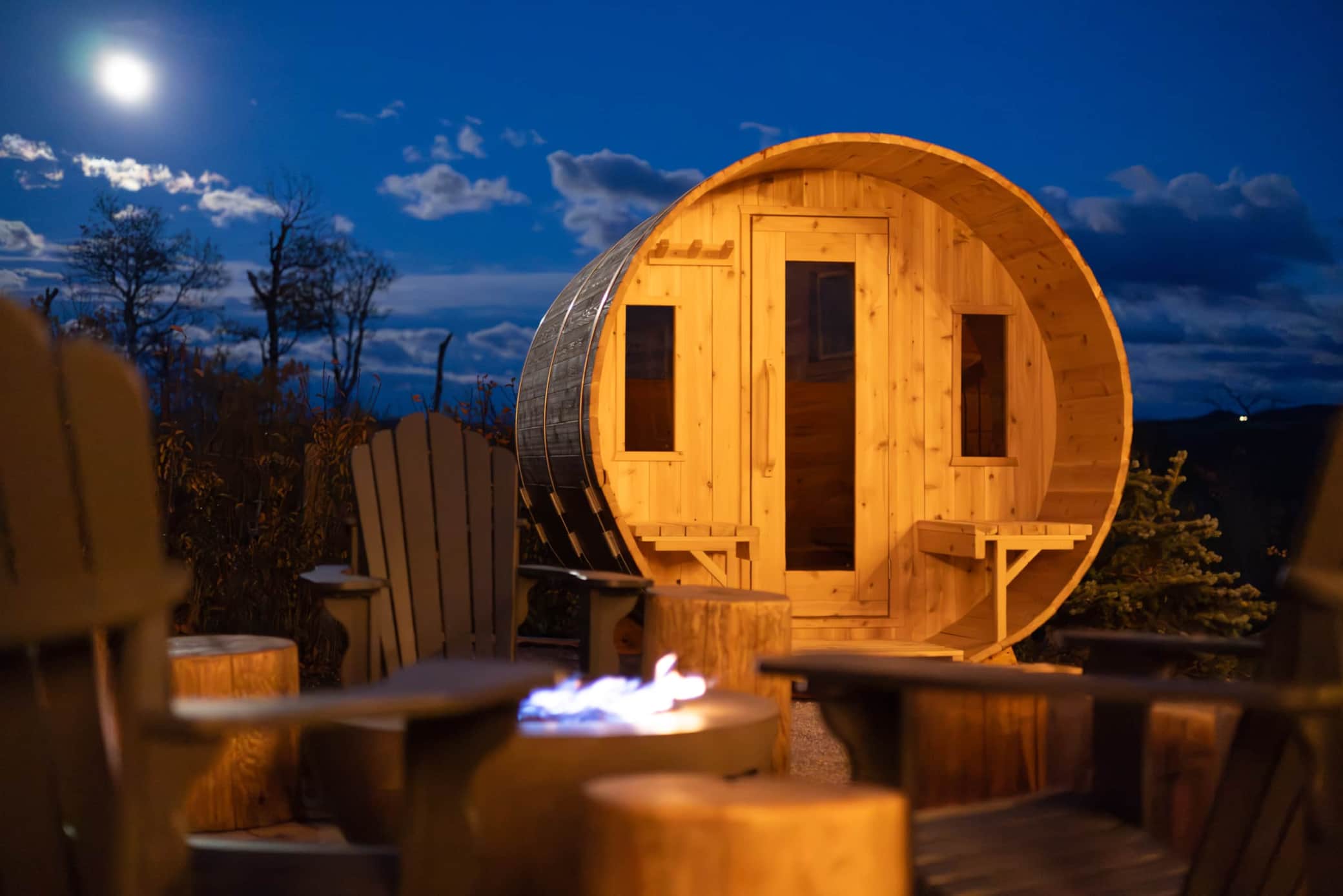 Escape and recover in the serene sauna and cool down near the fire table and adorandack chairs.jpg