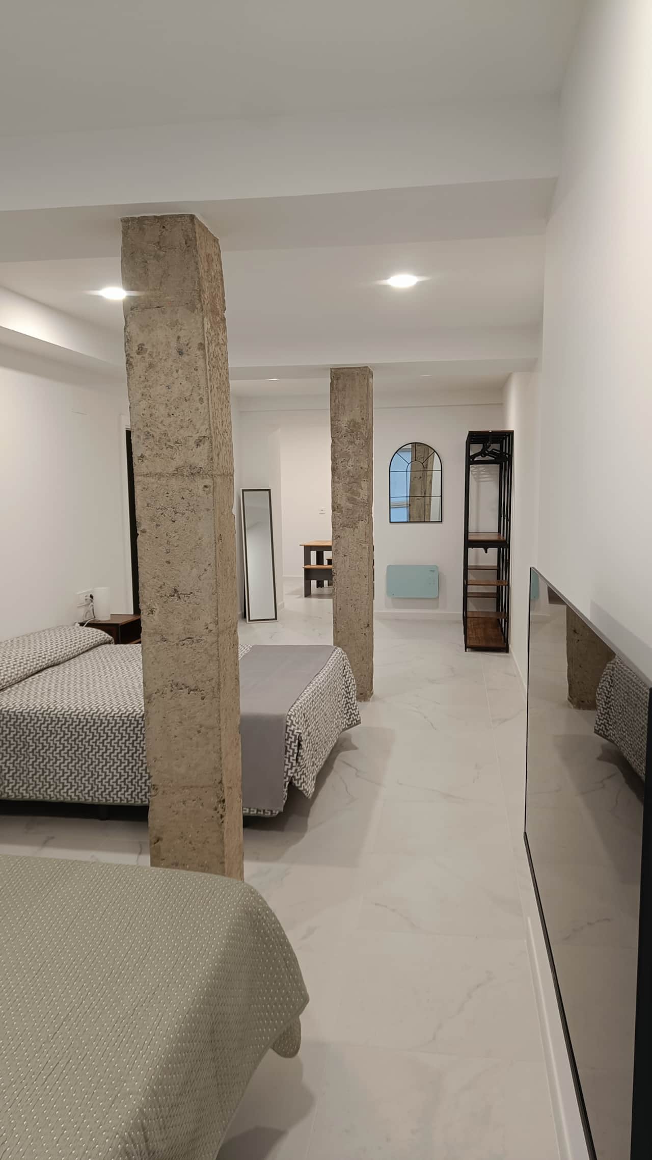 Vista del dormitorio con columnas y zona de vestidor