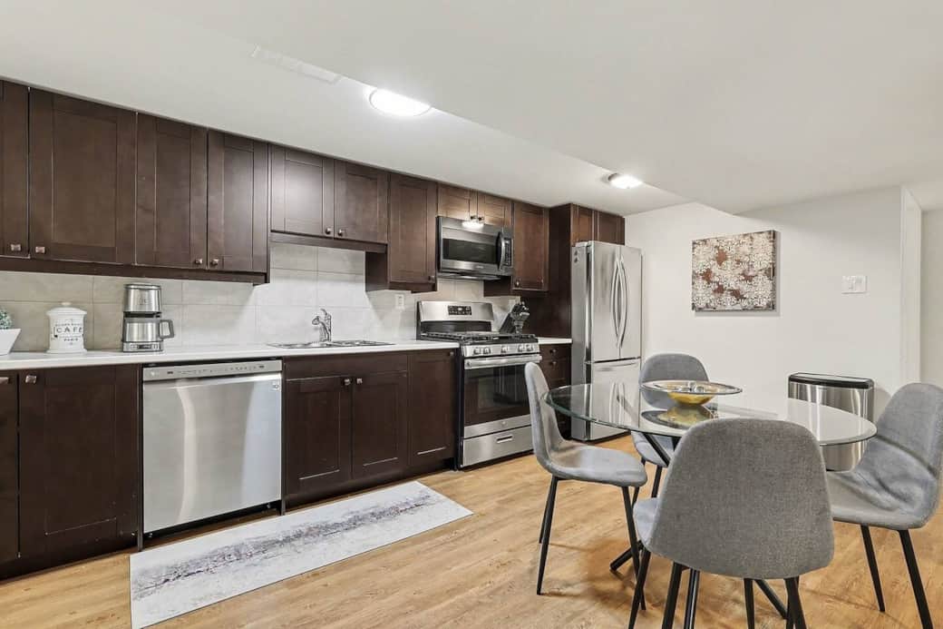 Prepare delicious home-cooked meals in this sleek, modern kitchen featuring stainless steel appliances and ample counter space in Ottawa.