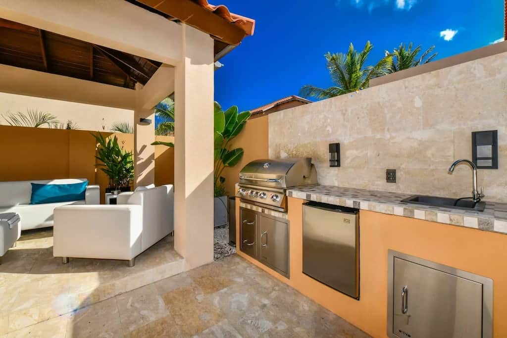 Backyard kitchenette with propane BBQ/grill, mini fridge and sink