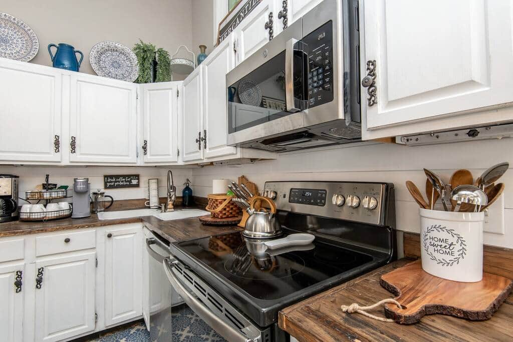 Kitchen view of electric stove & dishwasher.