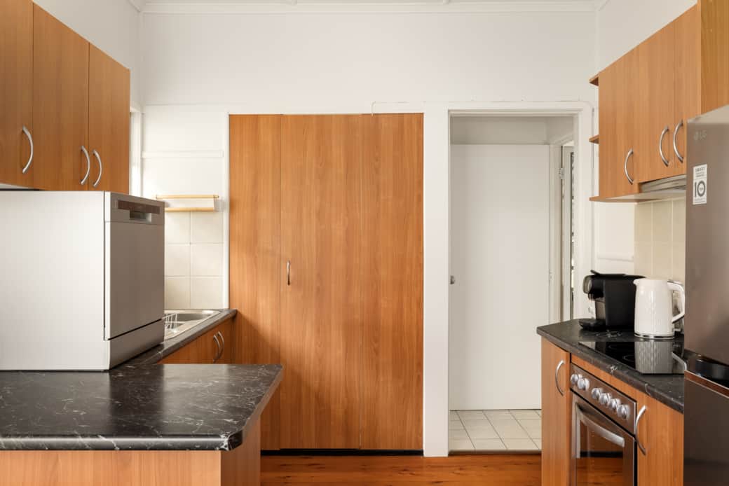 Kitchen: Sleek kitchen with ample storage, modern appliances Kitchen: Sleek kitchen with ample storage, modern appliances