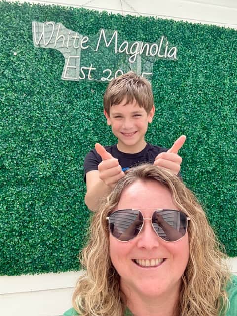 Family selfie in front of White Magnolia Galveston grass wall