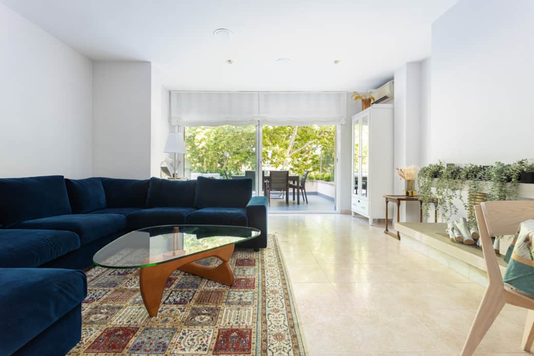Spacious living room with 6-seat sofa, sofa bed, and dining for 8
