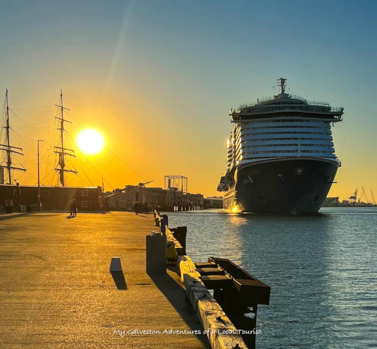 Galveston cruise terminal lit up at sunrise with ships departing