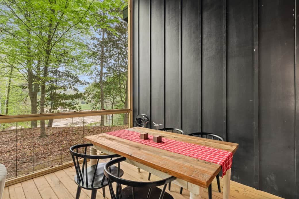 Gather, slow down, and take it in. The dining table is positioned to frame one of the best views on the property—overlooking the creek and the surrounding trees—so every meal feels a little more intentional.  
