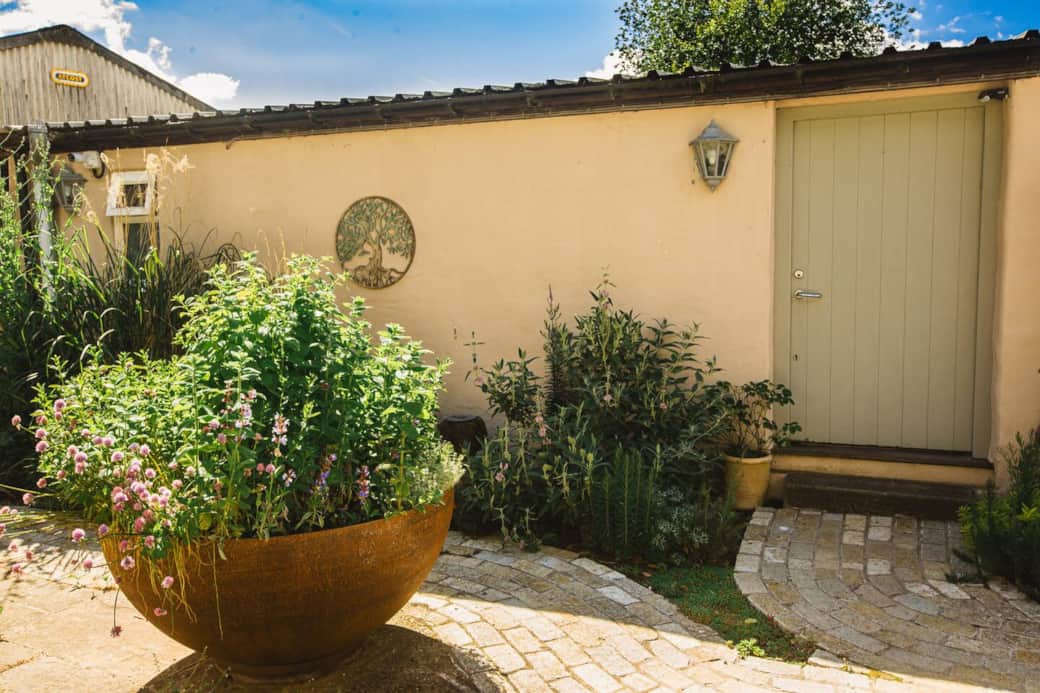 Entrance and herb garden in the large steel bowl on the left.