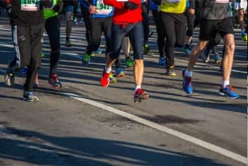 Mardi Gras themed 5K runners in Galveston wearing fun costumes