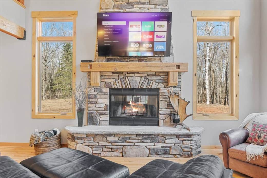 Kick back & relax on the large sectional couch and stream your favorite shows! Floor to ceiling stone fireplace.