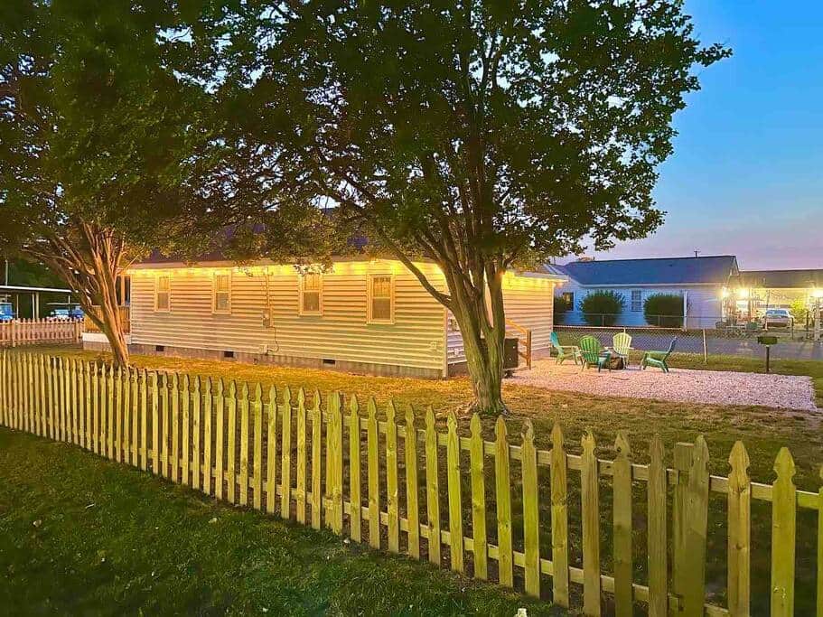 Large fenced private front and backyard, grass and mature trees