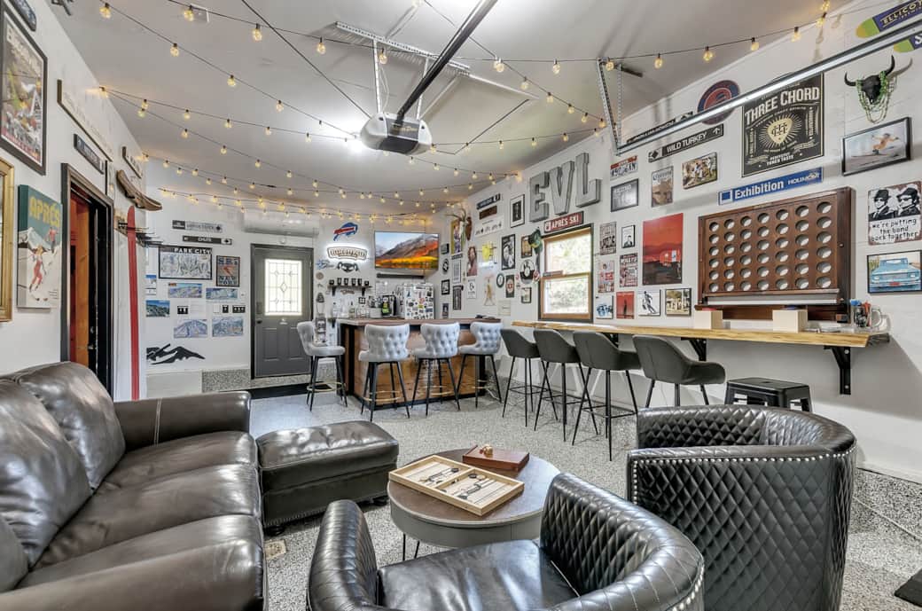 Shared après-style game room with lounge seating, bar area, darts, and games Shared après-style game room with lounge seating, bar area, darts, and games