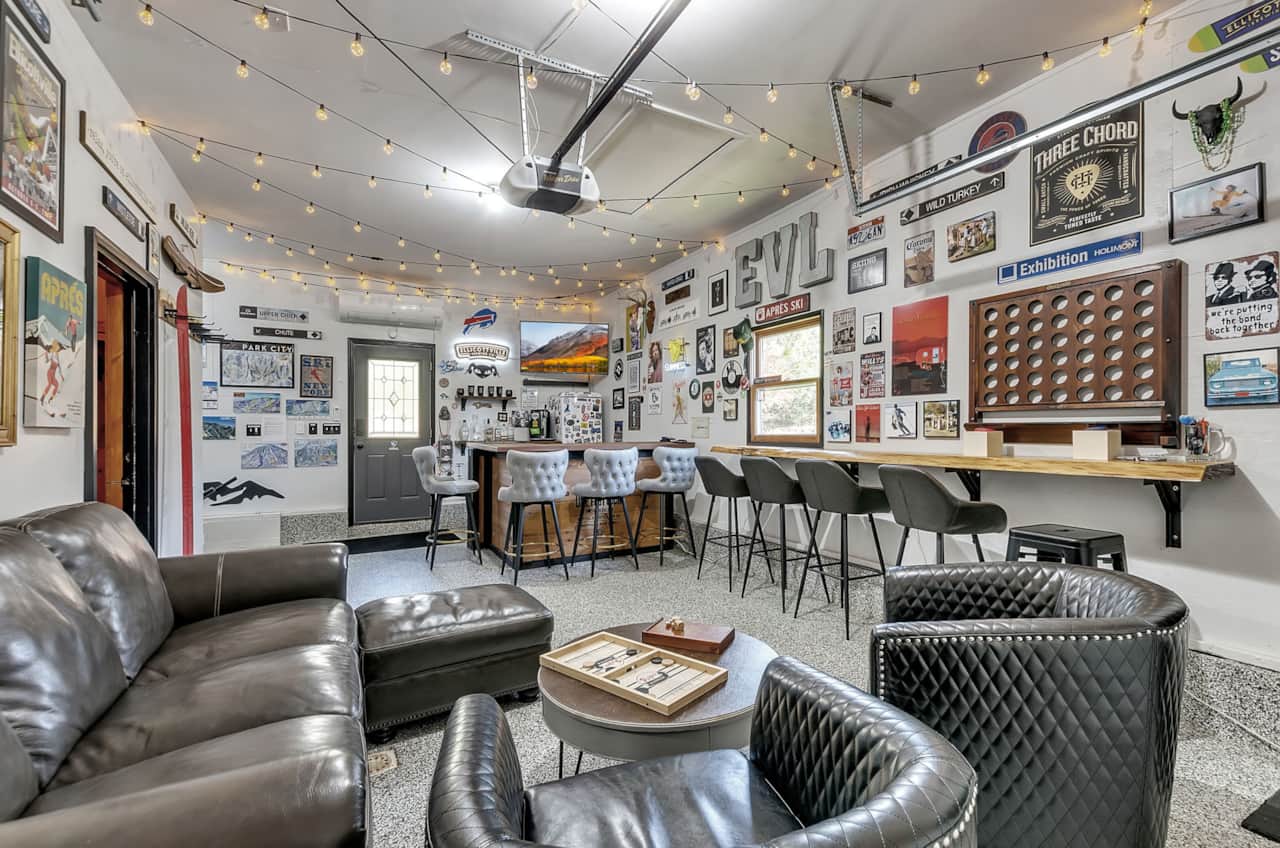Shared après-style game room with lounge seating, bar area, darts, and games