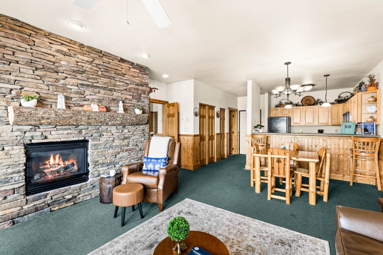 Comfort meets grandeur with plush seating, a warm hearth, and endless lake views
