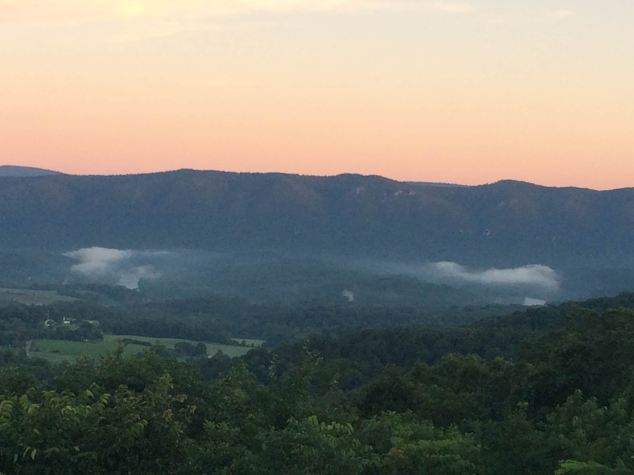 Clouds hover in the valley