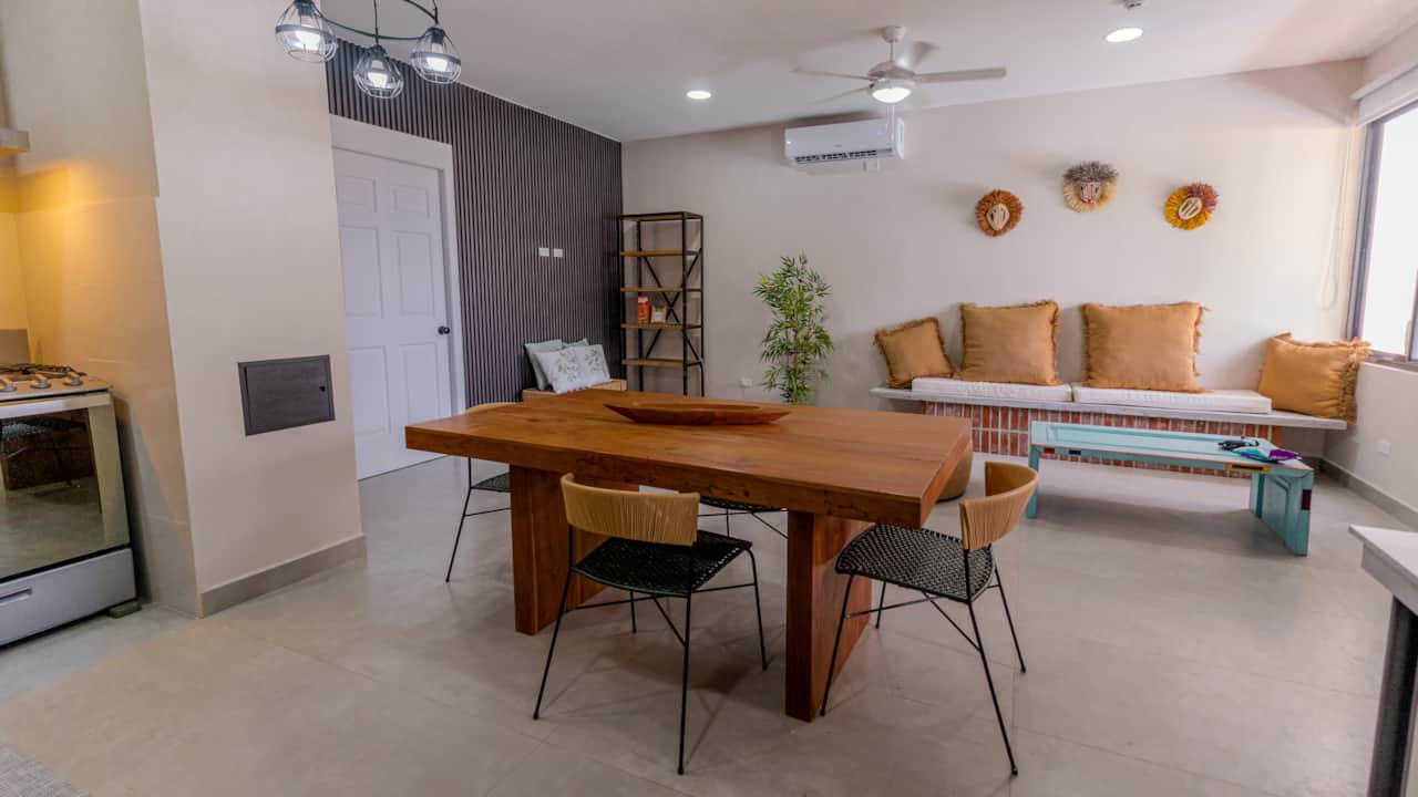 Gather around the live-edge wood table in the open living space of this Pedasí rental.