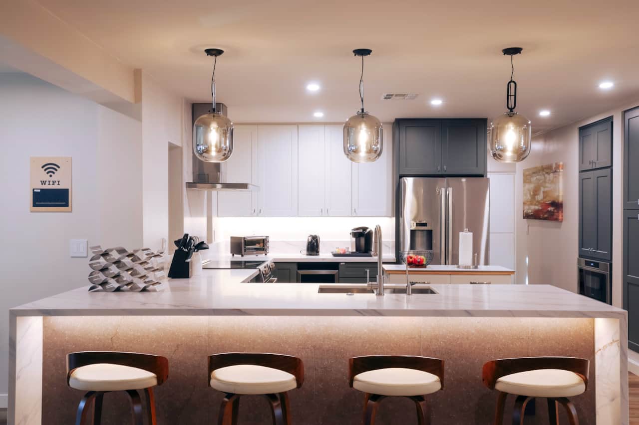 Modern kitchen with a waterfall island and seating for four.