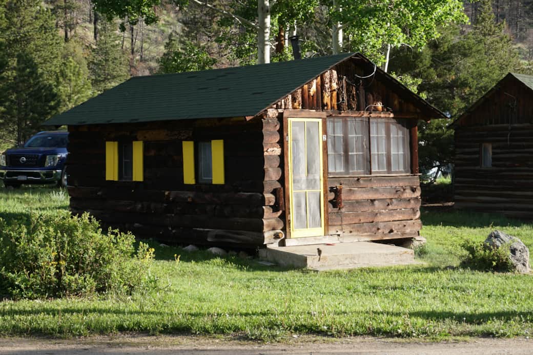 Cabin 2 has a small deck and a picnic table just outside.