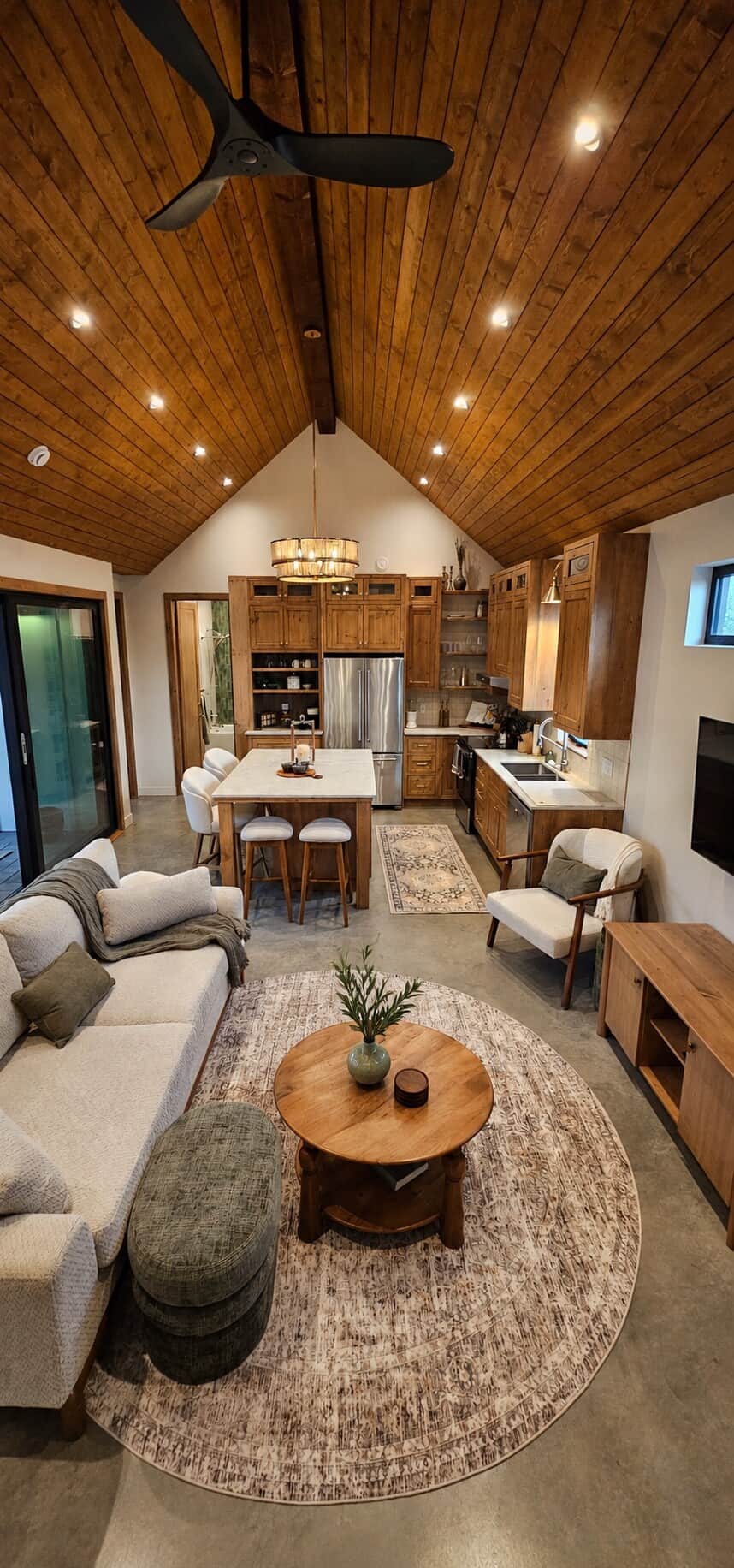 aulted cedar ceilings and an open-concept layout create a warm gathering space. A fully equipped kitchen, dining island for four, and spacious couch make it easy to unwind after exploring Okanagan wine country.