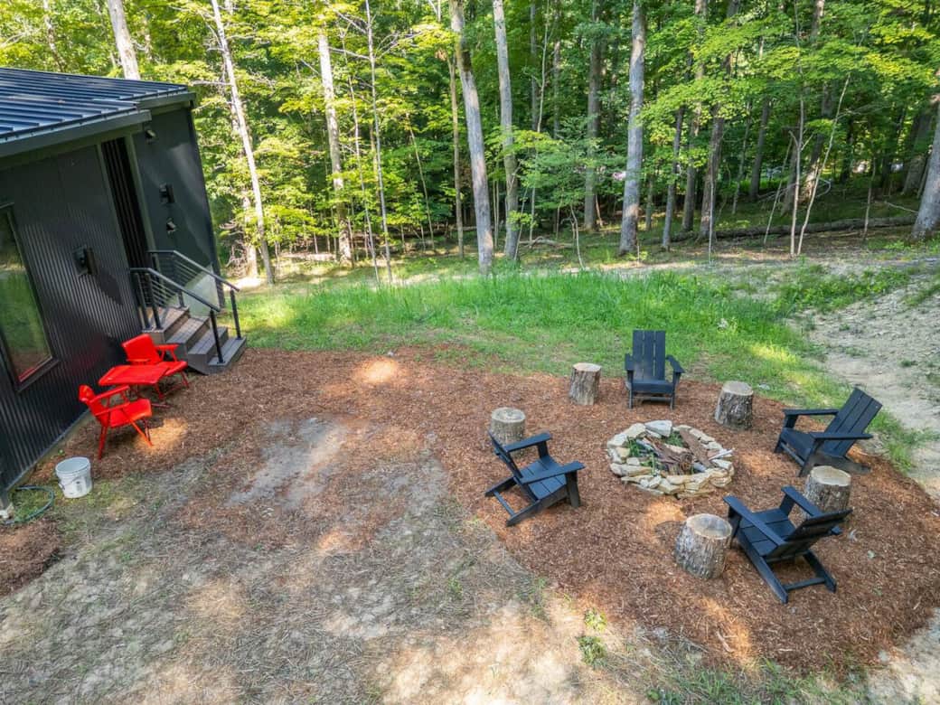 Enjoy a cozy night under the stars by the hand-crafted limestone fire pit, with plenty of firewood and comfortable Polywood chairs ready for you.