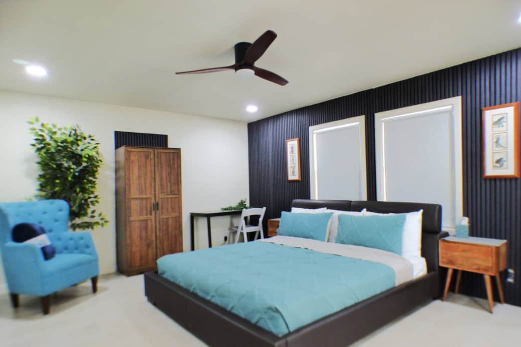 King bed inside a roomy bedroom with office desk when needed . Also has a door leading to the balcony that overlooks your private pool and BBQ area.
