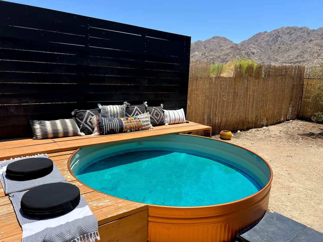 Private 8 foot cowboy pool with cushioned lounge deck — the perfect place to relax, read, or stargaze.