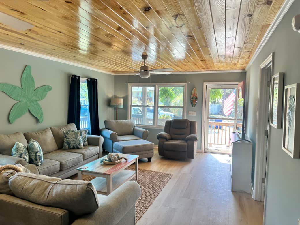 Open living room with pine plank ceiling