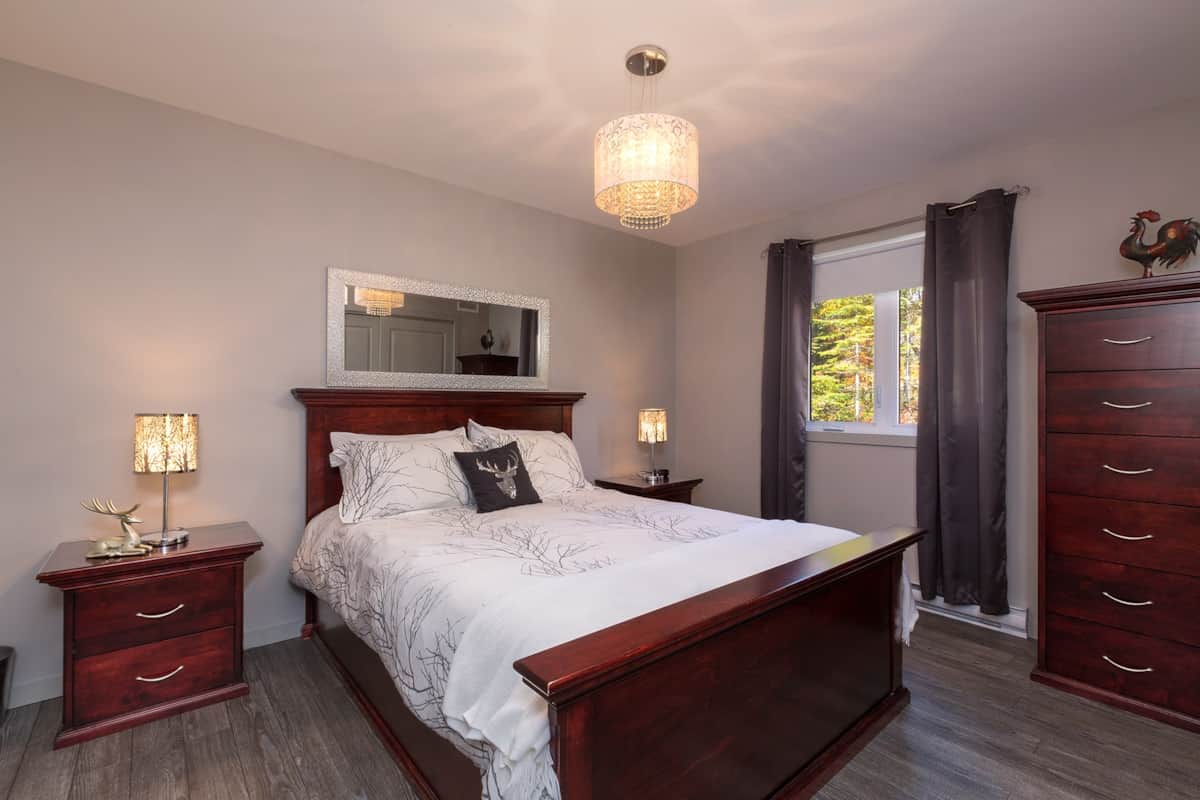 Big master bedroom with a queen bed and storages