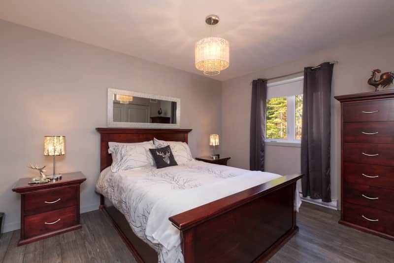 Big master bedroom with a queen bed and storages