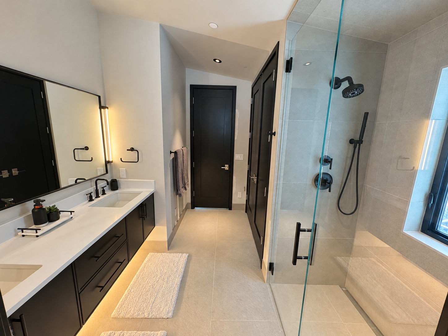 Second bedroom en suite with double vanity and walk-in shower.