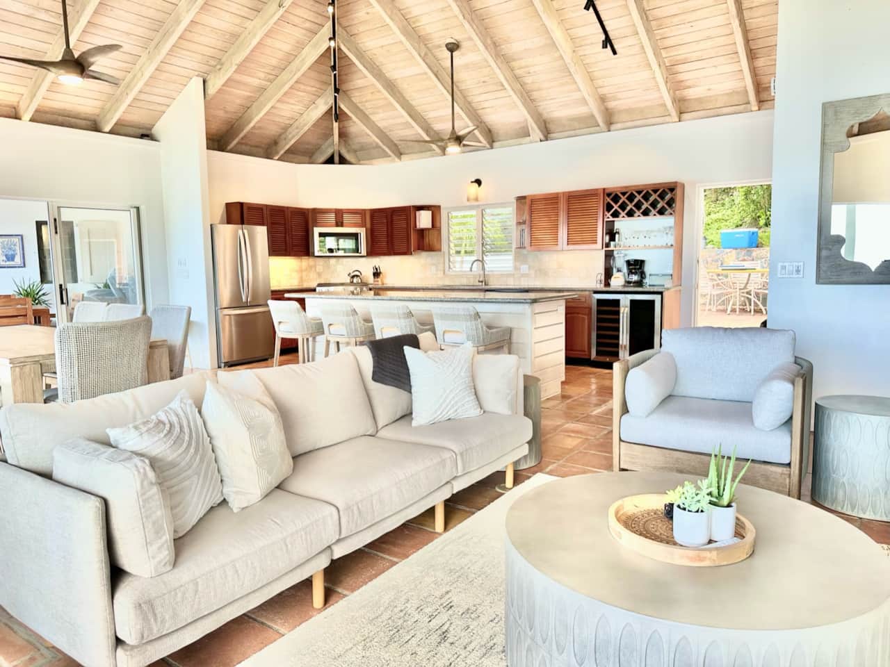 Seating in living room with kitchen in the back