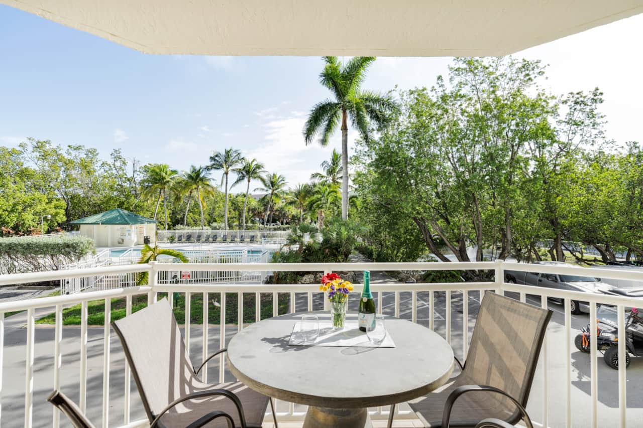 Private furnished balcony with outdoor seating, perfect for morning coffee or evening drinks.