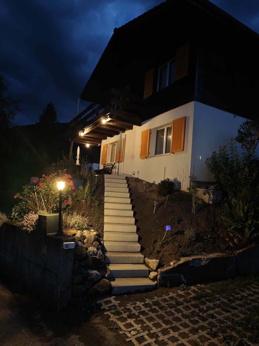 Illuminated entrance of Nebelmeer Chalet at dusk