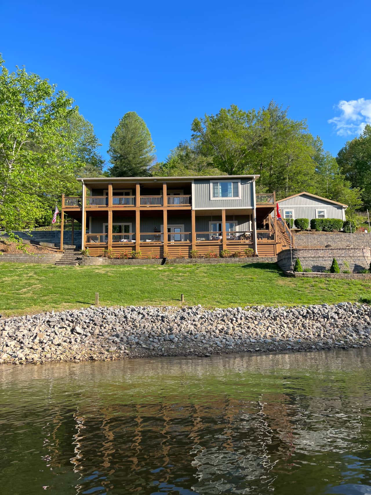 Only a small sloped yard between the house and the water