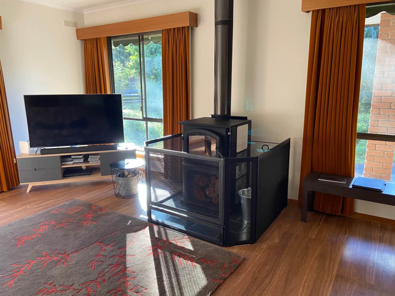 Cozy warmth with a slow combustion wood fire and child safety guard.