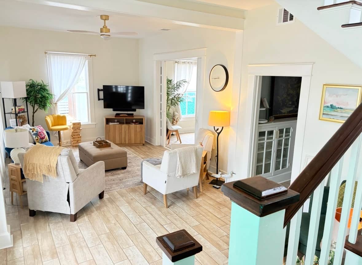 Wide angle view of the coastal living room and entry area.