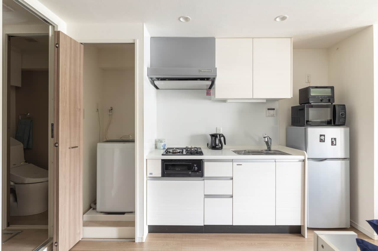 Well-planned compact kitchen with all essentials including in-unit laundry