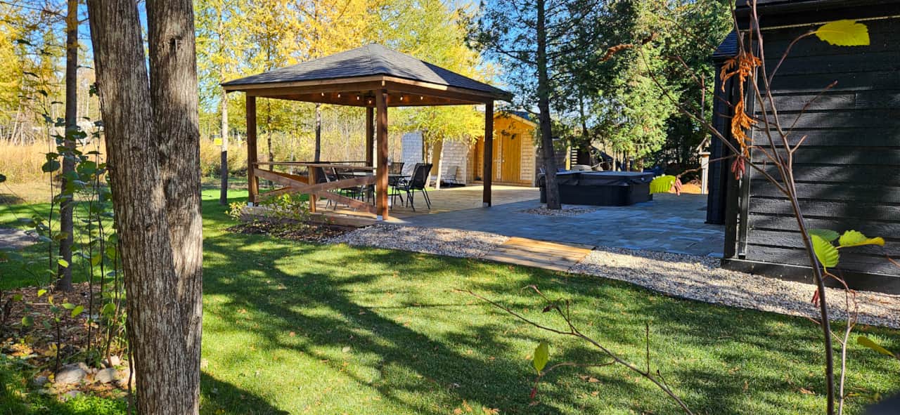 Covered Outdoor Gazebo with Green Lawn and Beautiful Forest Surroundings Near Falcon Lake