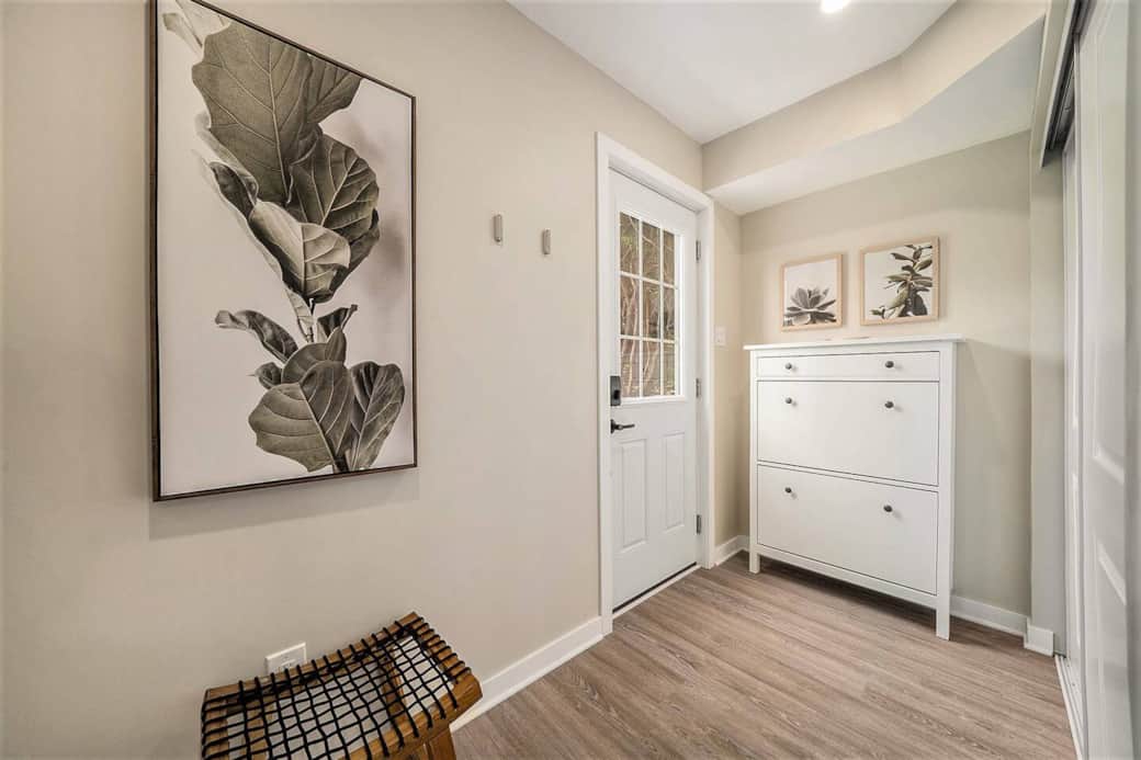 The entryway offers a large closet with hangers and a shoe cabinet. The entryway offers a large closet with hangers and a shoe cabinet.