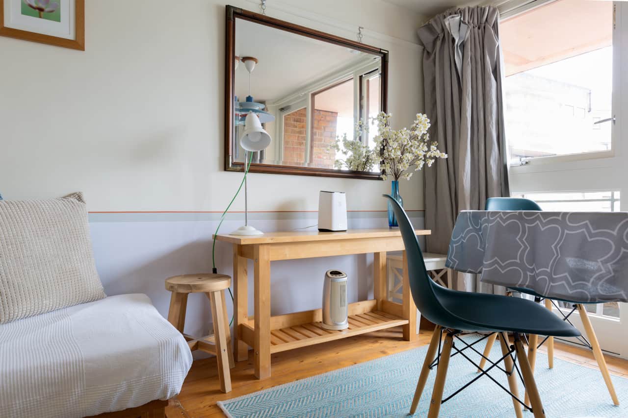 Console table, decorative mirror, and dining set bathed in natural light