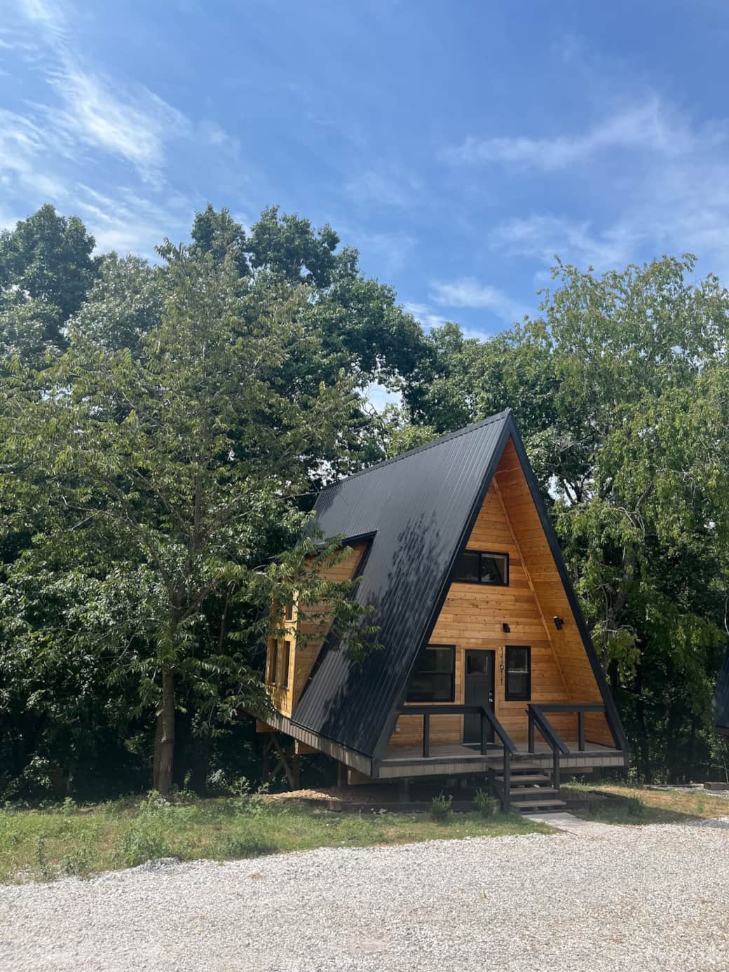 Our Perch is nestled in large trees over looking a deep Arkansas holler. A gravel parking area is located next to the cabin.